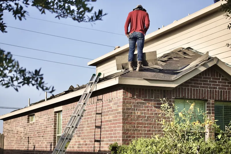 Professional roofer working on a residential roof in Cherokee Trail